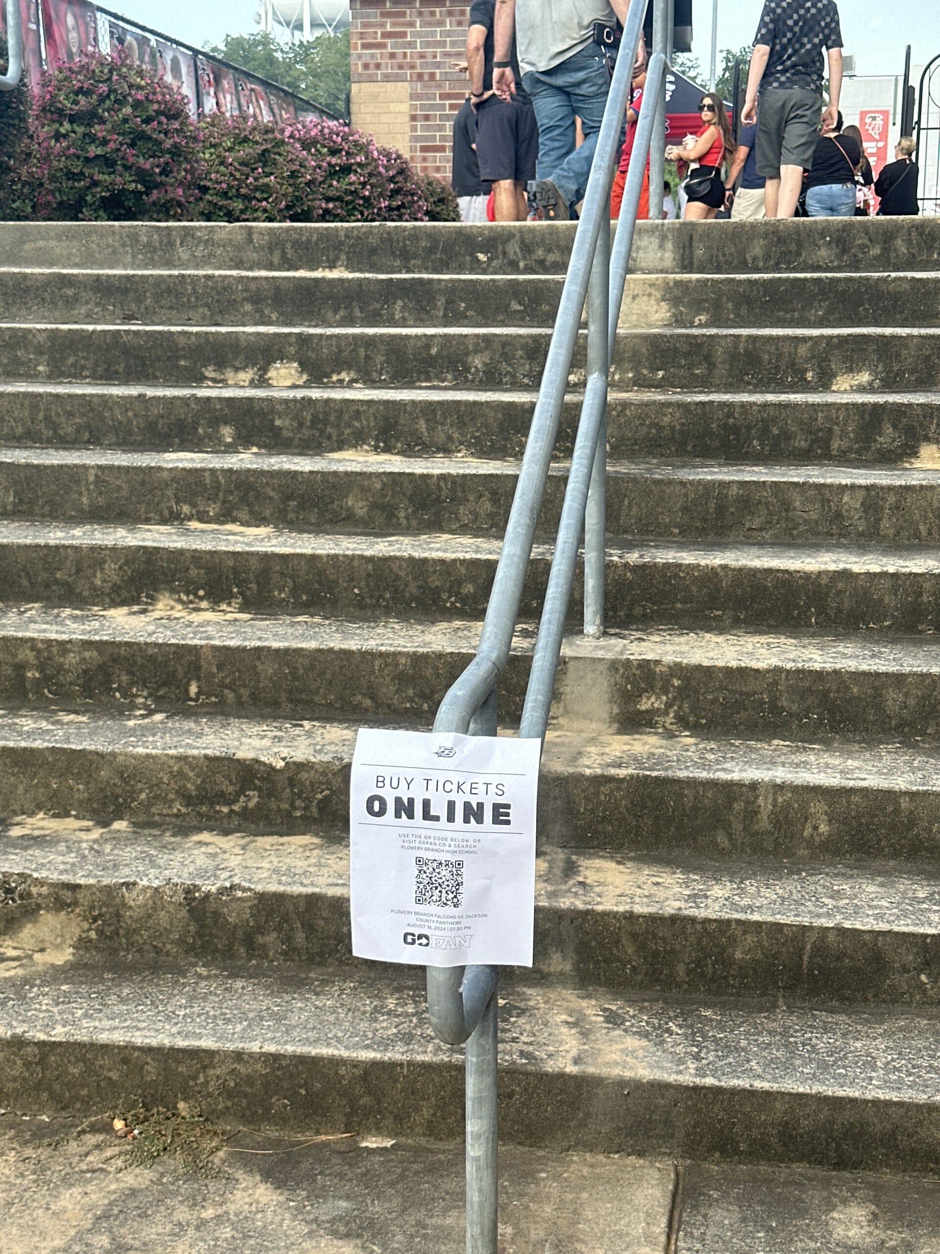 Paper showing "Buy tickets online" with a bold emphasis on "online", and a QR code with a link to the event itself.